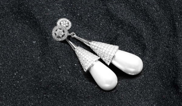 earrings on black sand background